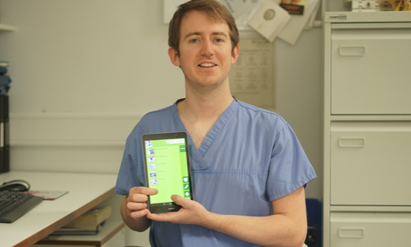 Richard Fitzgerald holding a tablet with Hear Me Now
